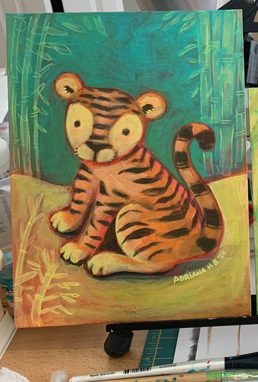baby tiger sits painting