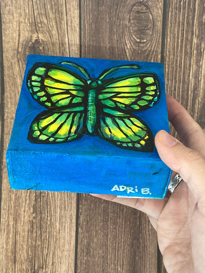 Butterfly on dark blue 4"/10cm square mini original painting of a butterfly on a primary blue background, by Adriana Bergstrom