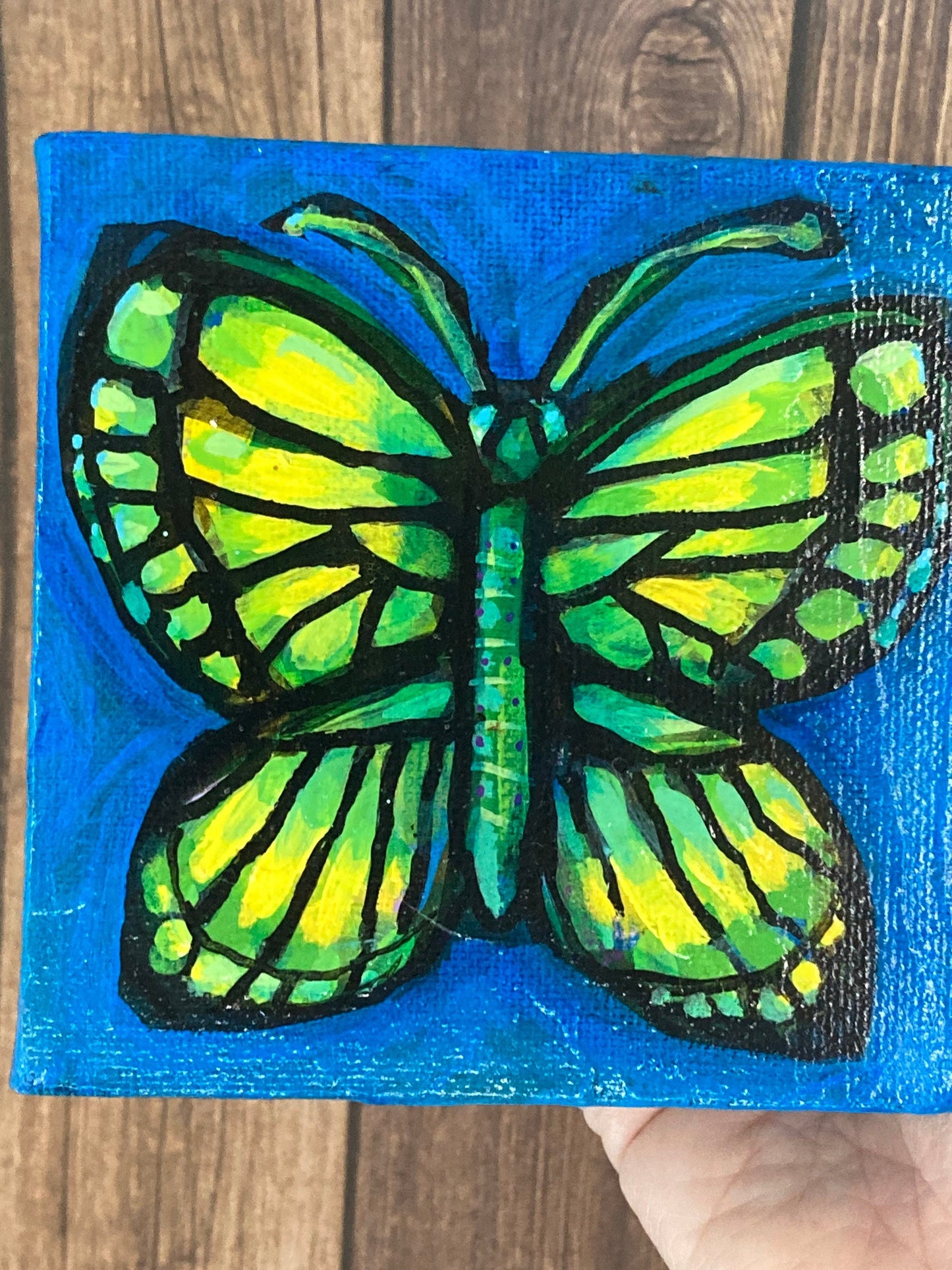 Butterfly on dark blue 4"/10cm square mini original painting of a butterfly on a primary blue background, by Adriana Bergstrom